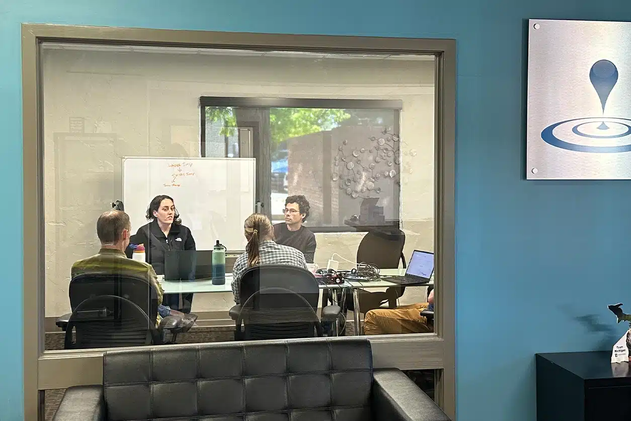 Photo of a team meeting in a conference room at in2being's office