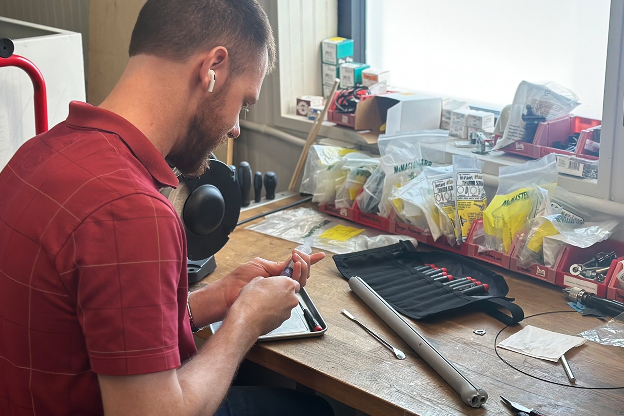 Photo of a man working on a product at a work bench